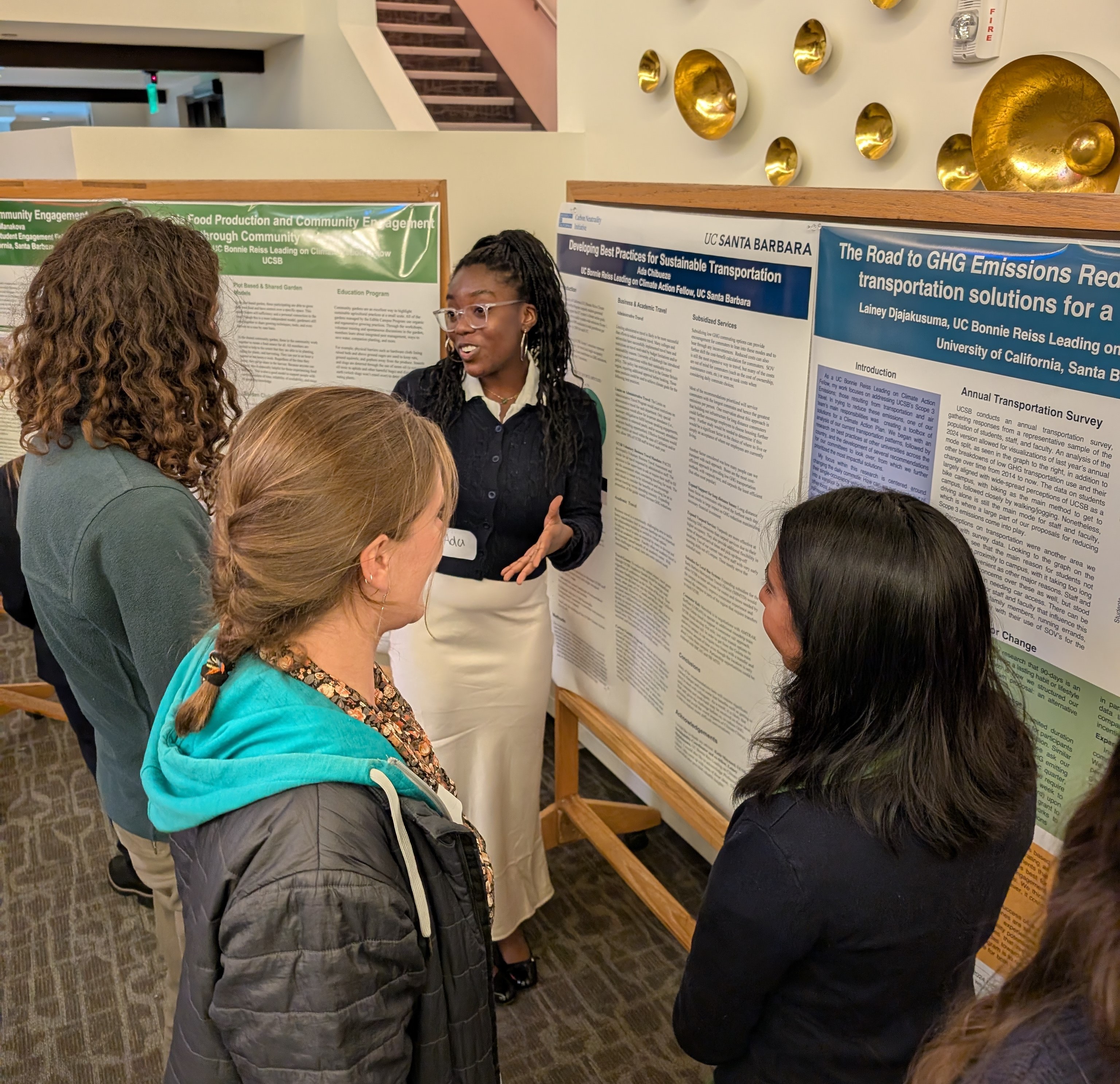 Student presents poster to Climate Council members.