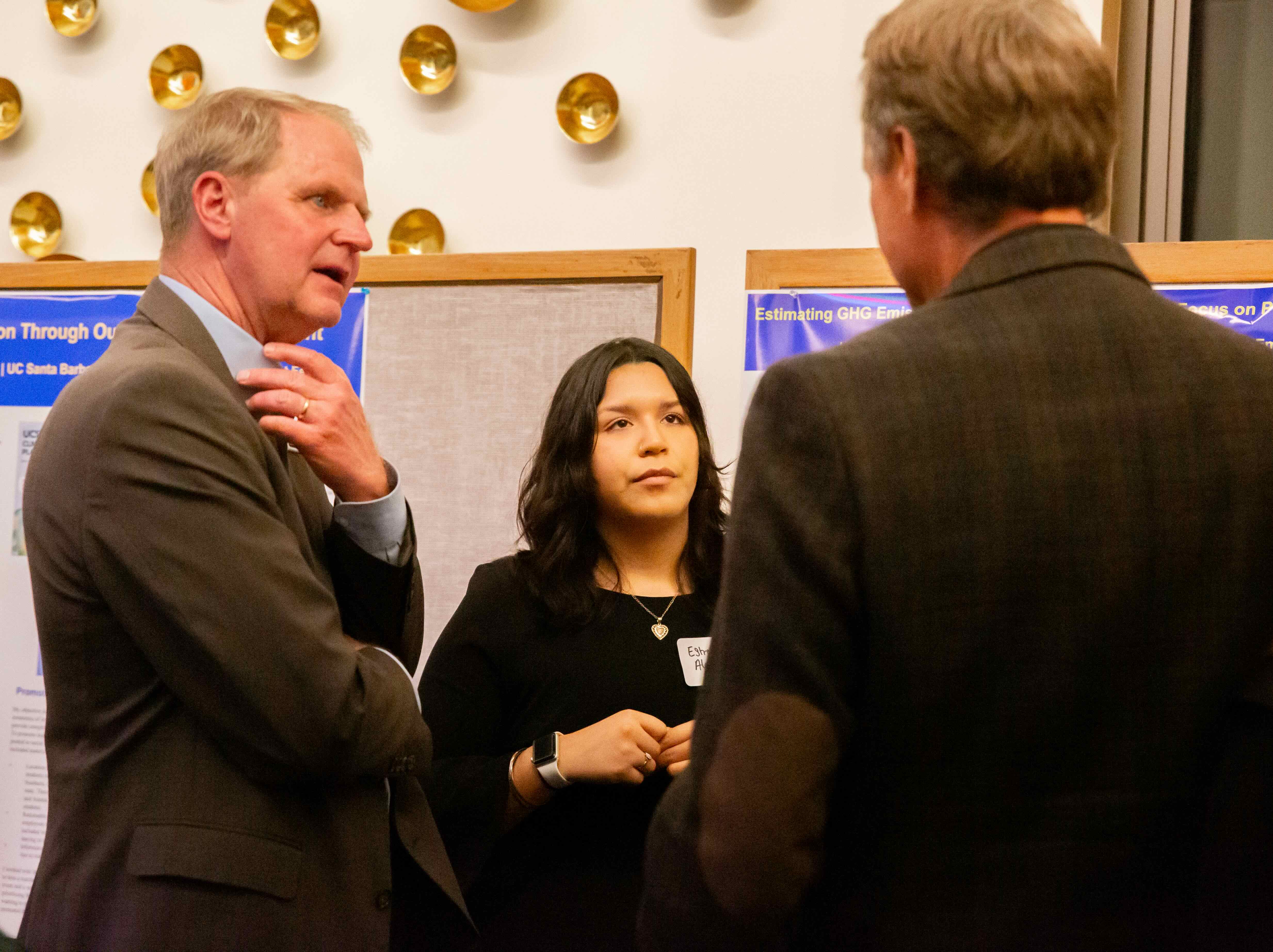 Estrella talking with two individuals at GCLC. 