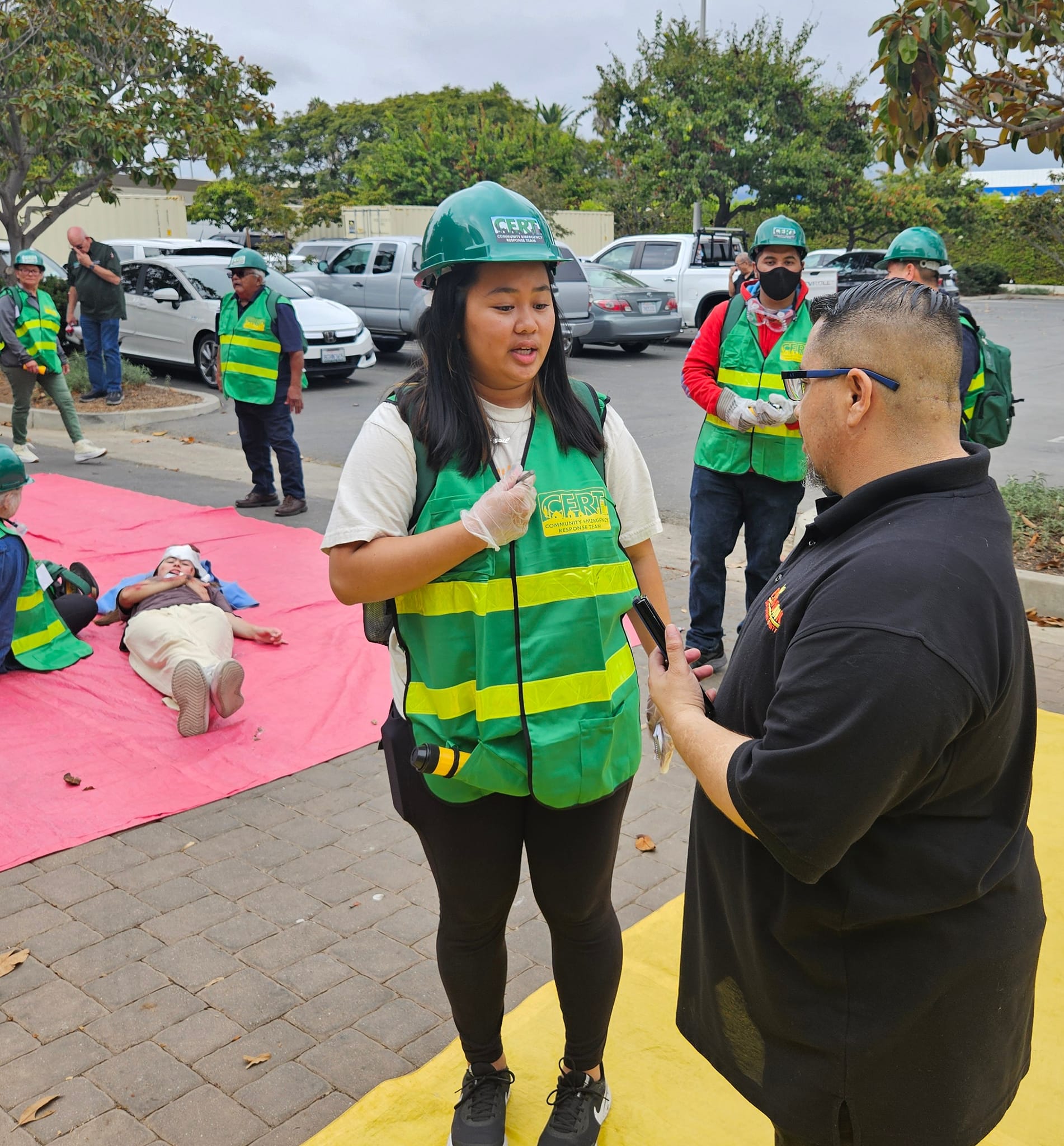 CERT Class, intern instructor advising a student in the class