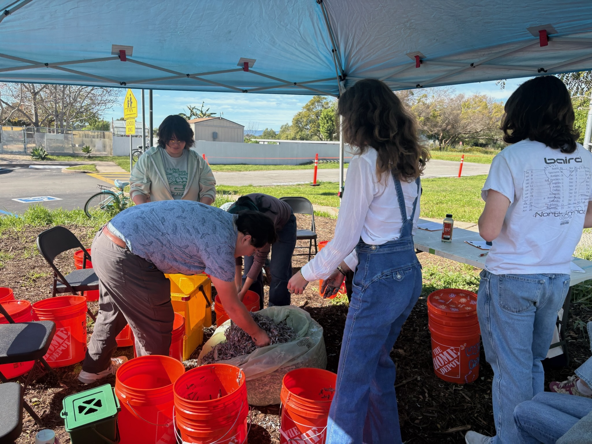 group of people at worm composting event. 